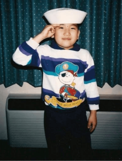 AJ as a boy, saluting